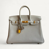 Bolsa Hermès Birkin 25 Gris Neve com Ferragens Gold