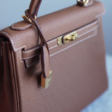 Bolsa Hermès Kelly 25 Togo Gold com Ferragens Gold