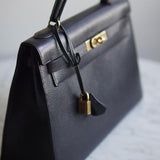 Bolsa Hermès Kelly 32 Taurillon Noir com Ferragens Gold